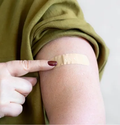 Bandage on the upper arm after a contraceptive implant procedure