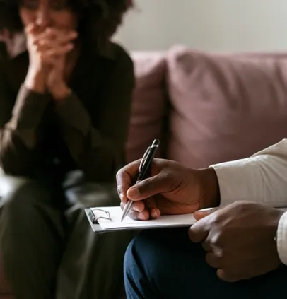Patient talking with a counsellor while notes are taken
